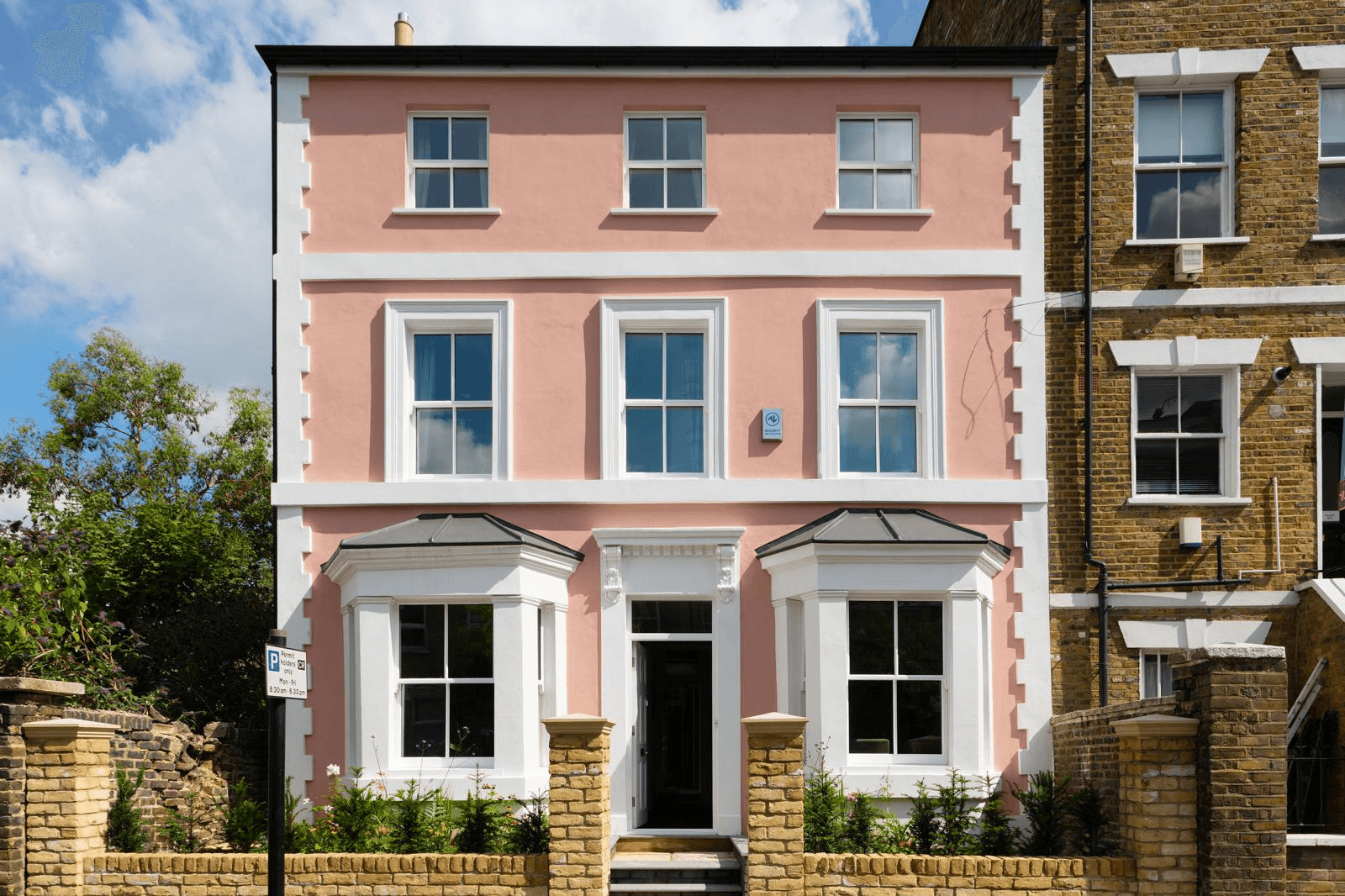 Pink rendered period house with white sash windows, Brighton & Hove